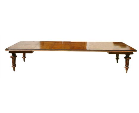 A Victorian pollard oak and ebonised wind-out extending dining table, c.1860, the rectangular top with a moulded edge, on tur