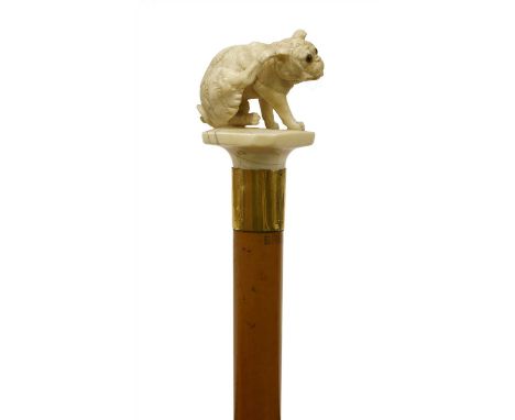 An ivory and malacca walking stick by Brigg of London , 19th century, the carved handle in the form of a dog, on a plain tape