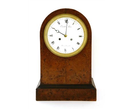 A French amboyna mantel clock, early 19th century, the arching case set with a white enamel dial with black Roman numerals, a