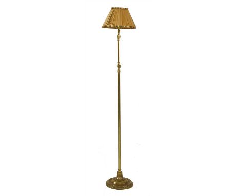 A French brass adjustable standard lamp , 19th century, with a tubular column, raised on a spreading circular base, 135cm at 
