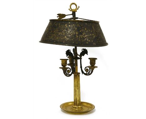 A French Empire toleware light, 19th century, the shade decorated with stars, over three scrolling arms, each cast with a coc