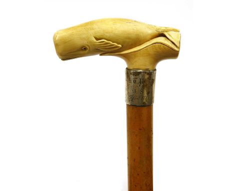 A marine ivory and malacca walking stick, late 19th century, the handle carved in the form of a sperm whale, with a silver mo