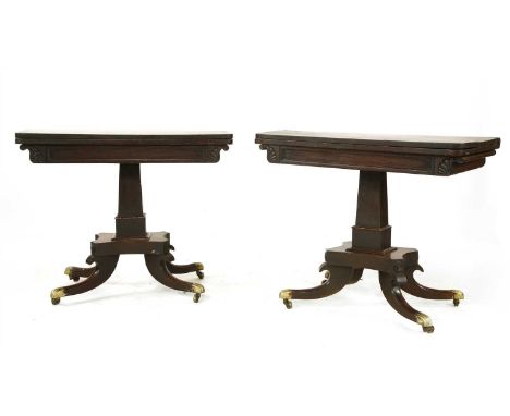 A pair of Regency mahogany card tables, each with a baize-lined playing surface, the frieze with a rectangular panel flanked 