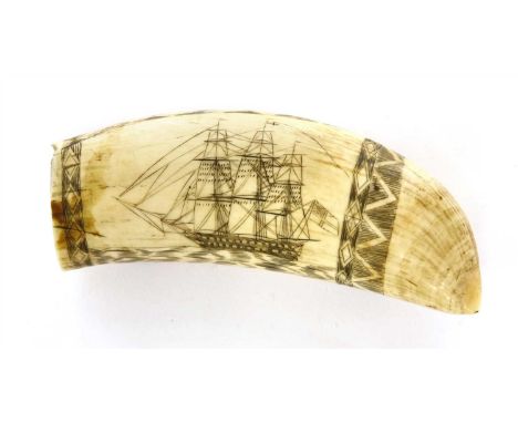 A scrimshawed whale's tooth, 19th century, decorated with a three-masted whaler flying the white ensign, the reverse with a w