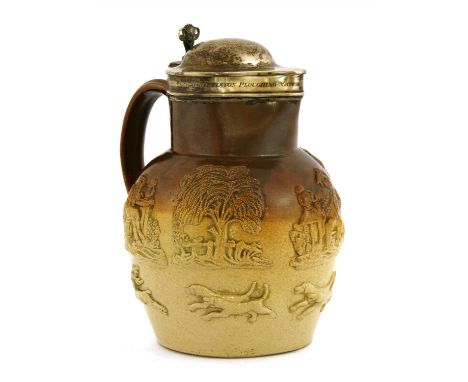 A William IV Mortlake-type jug, c.1839, the shaped hinged hallmarked silver lid set with a ram's head thumbpiece, the collar 