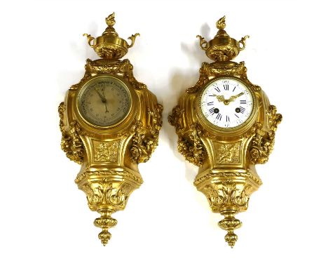 A French ormolu cartel clock and companion barometer, c.1900, in the Louis XVI style, each with a flaming urn surmount, over 