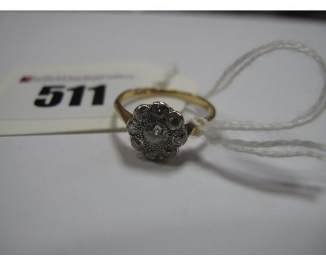 A Diamond Cluster Ring, of flowerhead design, millegrain set throughout with graduated old cut stones, stamped "PLAT" "18ct".