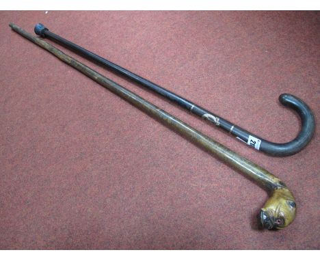 An Early XX Century Walking Cane with Bulldog Carved Handle, glass eyes, and a further walking stick with inlaid yellow metal