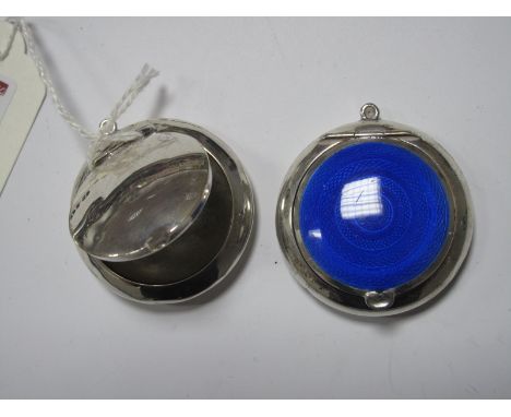 A Hallmarked Silver Compact, highlighted in blue enamel with internal mirror; together with another similar plain example. (2