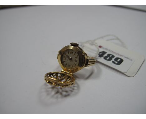 A Novelty Vintage Ring Watch, the signed dial with Arabic numerals and dagger markers, concealed by an openwork hinged circul