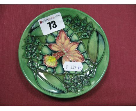 A Moorcroft Pottery Circular Pin Dish, painted in the Rainforest pattern, designed by Sally Tuffin, 11.5cm diameter.