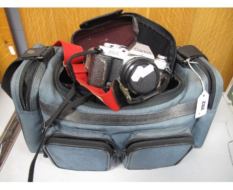 A Canon AL -1 35mm Film SLR Camera, Canon FD 50mm FI.8 lens, Canon FD 35-70mm F3.5-4.5 lens, flashgun, camera bag.