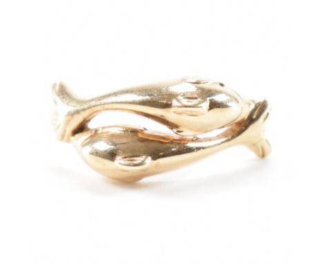 A hallmarked 9ct yellow gold crossover twin dolphin ring. The ring having two tessellating dolphins to the head in crossover 