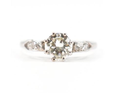 An early 20th Century platinum and diamond ring. The ring being set with a round brilliant cut diamond to the centre with scr