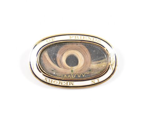 A late 18th Century Georgian antique gold and enamel mourning brooch. The brooch of oval form with white and blue enamelled b