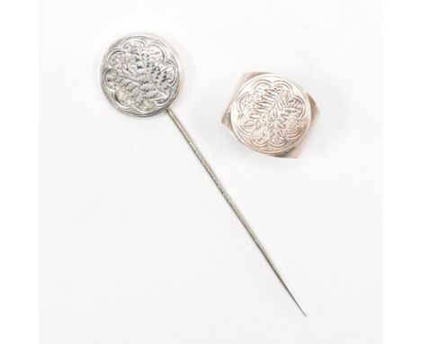 A 19th Century Victorian silver stick pin with round foliate design finial, together with a later 20th Century silver ring ma