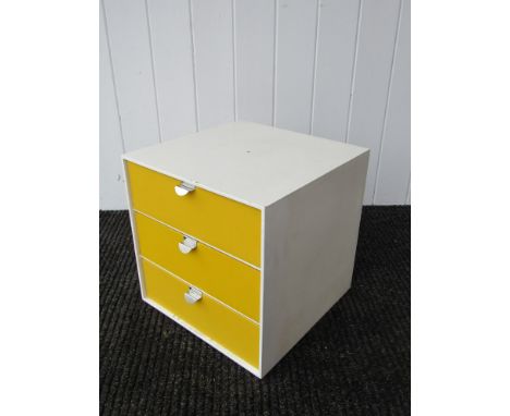 A Palaset cube with three yellow drawers 