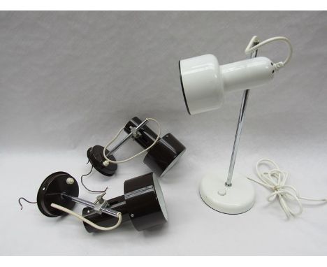 A pair of adjustable wall mounted spot lamps with brown shades and a similar white desk lamp