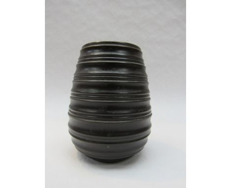 A Poole free form vase, oviform with ribbed body, treacle glaze. 12.5cm high 