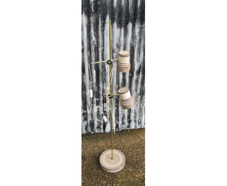 A Danish brassed standard lamp with twin adjustable ceramic spots and ceramic base
