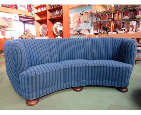 A 1940's Danish curved three seater sofa with twin tone blue cord upholstery 