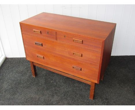 A Danish teak low chest of two short over two long drawers raised on square legs.  90cm x 42cm x 73cm high