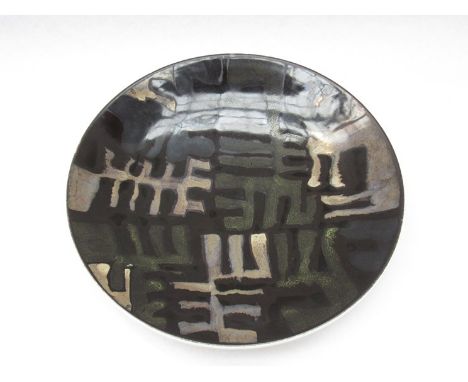 A Poole Studio range dish, black ground with geometric forms in slate grey, buff and green. 26.5cm diameter 