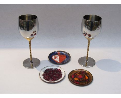 Two Viners stainless steel wine goblets designed by Stuart Devlin with three small enamelled metal abstract design pin dishes