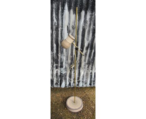 A Danish brassed standard lamp with single adjustable ceramic spot and ceramic base