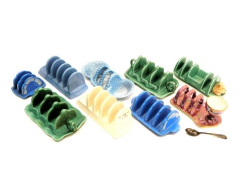 A quantity of Sylvac, Bretby and other toast racks, mainly Art Deco in style, to include an example mounted with a terrier, a