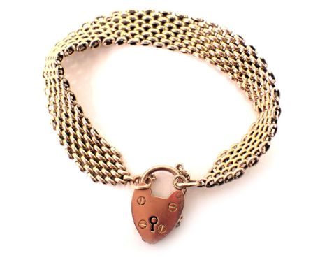 A gate bracelet, with layered design, with heart shaped padlock and safety chain, yellow metal unmarked, 18cm long, 22.9g all
