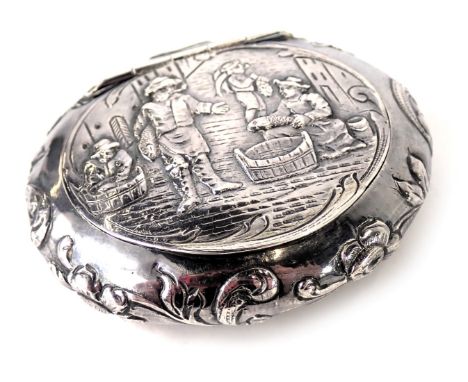 A continental white metal trinket box, of oval design with an embossed detail of fisherman, and scroll border stamped sterlin