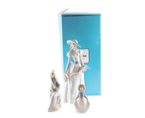 A large Lladro porcelain figure of a lady with flowers, Fragrances and Colours, model number E662X, 40cm high, a further Llad