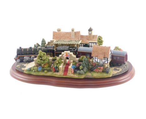 A large Lilliput Lane model of The Royal Train at Sandringham, on a shaped mahogany base, 32cm long. 