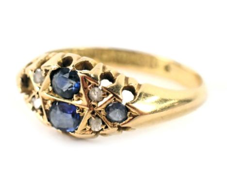 An 18ct gold gypsy ring, set with four oval sapphires (1 missing) and four tiny diamonds, each in claw setting, ring size K½,