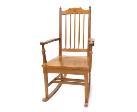 An Alan 'Acornman' Grainger oak rocking chair, with spindle turned back, solid seat and shaped arms, on faceted legs with roc