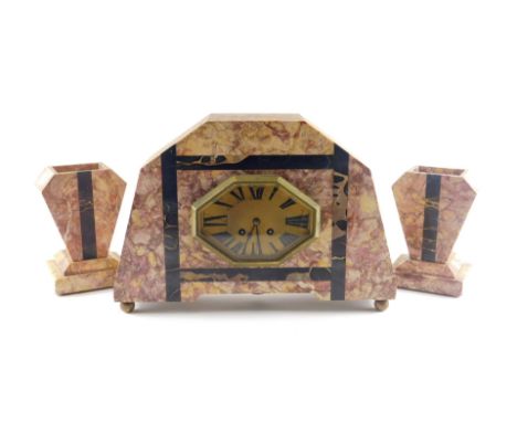A French Art Deco purple and black variegated marble clock garniture, the clock with octagonal bezel and Roman numeric dial, 