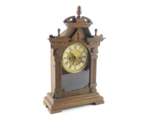 A late 19th/early 20thC American mantel clock, in a stained oak case with Roman numeric dial, on block feet, 50cm high. 