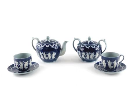 A Copeland ceramic part tea set, decorated in Wedgwood style with raised neoclassical figures in white on a deep blue ground,