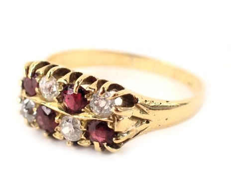 A ruby and diamond two row dress ring, each set with four rubies and four diamonds, in claw setting on a yellow metal band, w