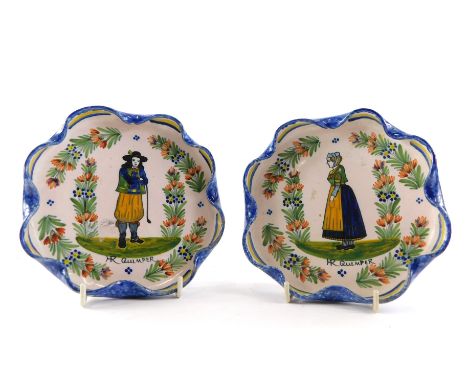 A pair of early 19thC HR Quimper fluted faience cabinet plates, each polychrome decorated with central figure in flower garde