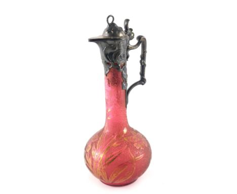 A WMF acid etched cranberry tinted glass and pewter mounted claret jug, the lid, handle etc. decorated with typical Art Nouve