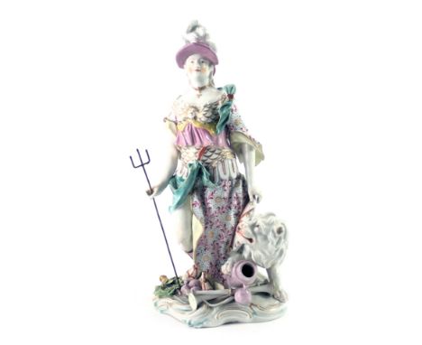 A continental porcelain figure of Britannia in Derby style, standing beside a lion, carrying a trident, on rococo scroll base