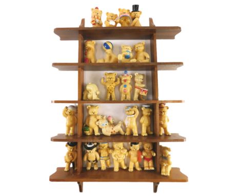 A large collection of ceramic bears, each wearing costume, etc., and a shelf. 