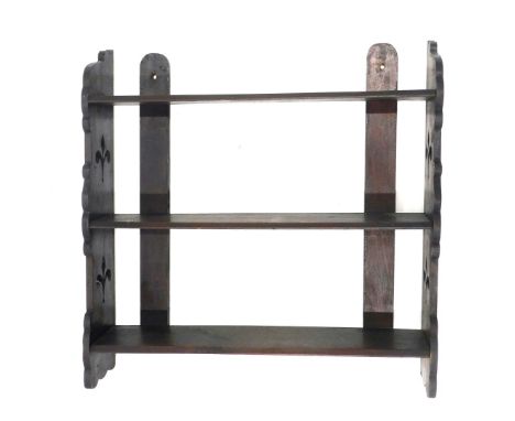 A late 19thC beech wall shelf, with pierced end supports, 50cm wide. 