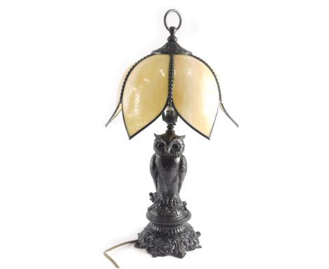 A bronzed metal owl table lamp, with marbled stain glass shade, and owl shaped support, 57cm high. WARNING! This lot contains