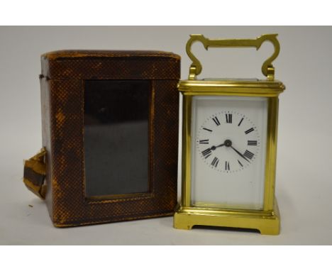 A French brass-cased mantel clock with enamel dial and bevelled glass, 15 cm high overall, with leather travelling case Good 