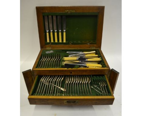 An oak canteen with hinged top and two drawers, fitted with an extensive part set of OEP electroplated flatware including tab