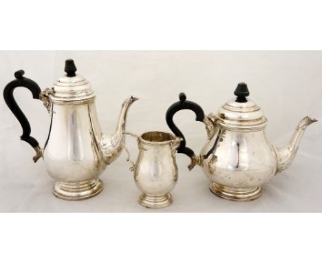 A three piece tea and coffee service in early George III style the baluster bodies with moulded leaf cast spouts, ebonised fi