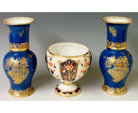 A pair of Carltonware vases in Chinese style the powder blue grounds decorated in gilt and coloured enamels with Chinoiserie 